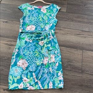 A Lilly Pulitzer dress, medium size . Turquoise with colored spring flowers.